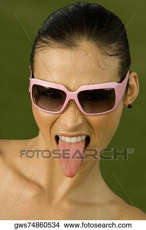 Close-up of a mid adult woman sticking out her tongue View Large Photo Image Picture - Close-up of a mid adult woman sticking out her tongue. Fotosearch