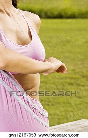 Close-up of a mid adult woman stretching View Large Photo Image Stock Image - Close-up of a mid adult woman stretching. Fotosearch