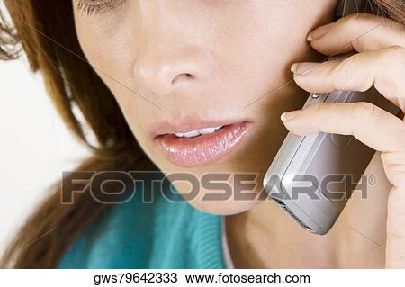Close-up of a mid adult woman talking on a mobile phone View Large Photo Image Stock Image - Close-up of a mid adult woman talking on a mobile phone. Fotosearch