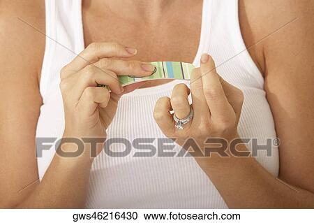Close-up of a mid adult woman using a nail file View Large Photo Image Stock Image - Close-up of a mid adult woman using a nail file. Fotosearch