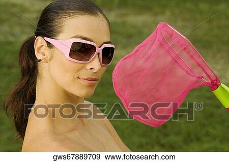 Close-up of a mid adult woman with a butterfly net View Large Photo Image Stock Photo - Close-up of a mid adult woman with a butterfly net. Fotosearch