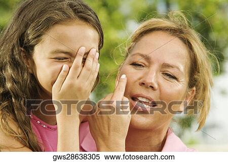 Stock Photography - Close-up of a mother gesturing to her daughter. Fotosearch