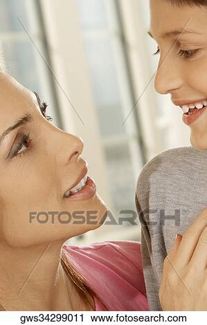 Close-up of a mother looking at her son View Large Photo Image Stock Image - Close-up of a mother looking at her son. Fotosearch