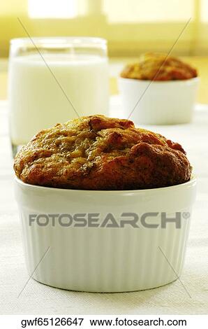 Close-up of a muffin and a glass of milk View Large Photo Image Stock Photo - Close-up of a muffin and a glass of milk. Fotosearch