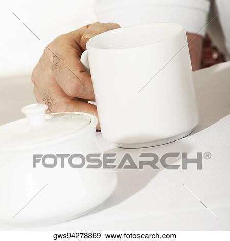 Close-up of a person's hand holding a mug View Large Photo Image Stock Photo - Close-up of a person's hand holding a mug. Fotosearch