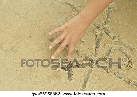 Close-up of a person's hand playing tic-tac-toe in sand View Large Photo Image Stock Image - Close-up of a person's hand playing tic-tac-toe in sand. Fotosearch