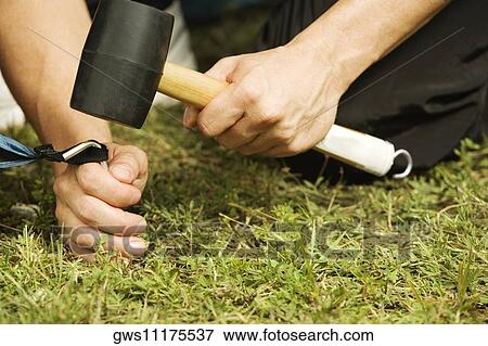 Close-up of a person's hand putting up a tent View Large Photo Image Stock Photo - Close-up of a person's hand putting up a tent. Fotosearch