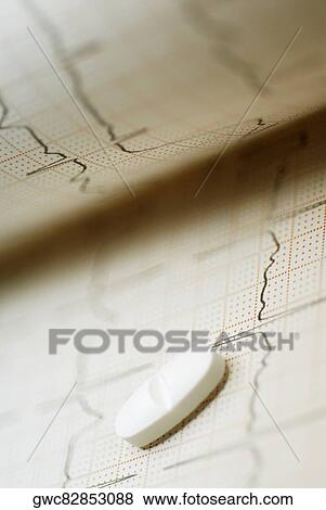 Close-up of a pill on an ECG report View Large Photo Image Stock Photo - Close-up of a pill on an ECG report. Fotosearch