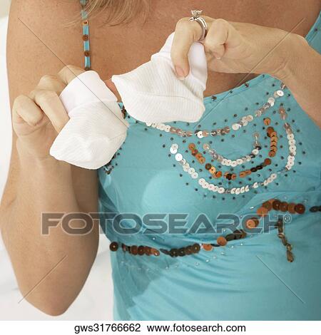 Close-up of a pregnant woman holding baby booties View Large Photo Image Stock Image - Close-up of a pregnant woman holding baby booties. Fotosearch