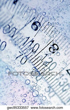 Stock Photo - Close-up of a protractor and a ruler in water. Fotosearch