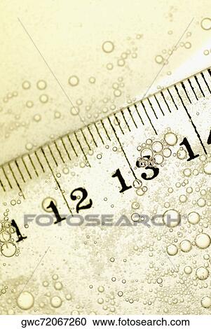 Close-up of a ruler in water View Large Photo Image Stock Image - Close-up of a ruler in water. Fotosearch