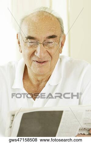 Close-up of a senior man reading a newspaper View Large Photo Image Stock Photo - Close-up of a senior man reading a newspaper. Fotosearch