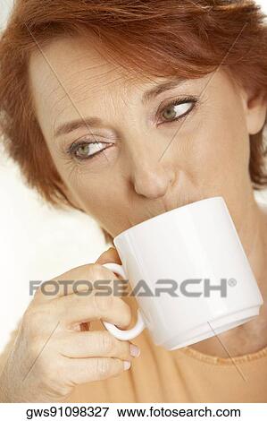 Close-up of a senior woman drinking a cup of coffee View Large Photo Image Stock Photo - Close-up of a senior woman drinking a cup of coffee. Fotosearch