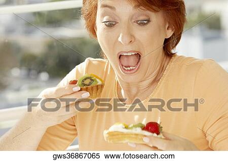 Close-up of a senior woman looking at a fruit tart View Large Photo Image Stock Photography - Close-up of a senior woman looking at a fruit tart. Fotosearch