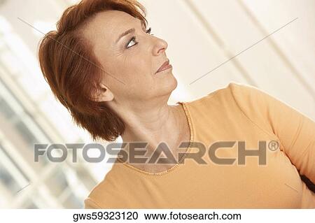 Close-up of a senior woman looking sideways View Large Photo Image Stock Image - Close-up of a senior woman looking sideways. Fotosearch