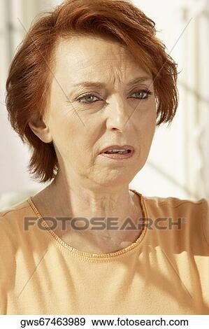 Close-up of a senior woman looking serious View Large Photo Image Stock Photo - Close-up of a senior woman looking serious. Fotosearch