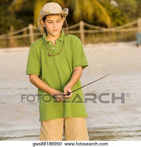 Close-up of a teenage boy holding a fishing rod View Large Photo Image Stock Image - Close-up of a teenage boy holding a fishing rod. Fotosearch