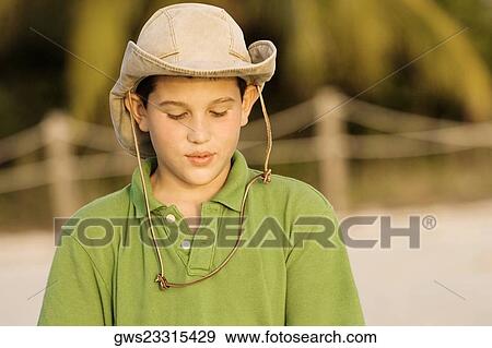 Close-up of a teenage boy looking down View Large Photo Image Stock Photo - Close-up of a teenage boy looking down. Fotosearch