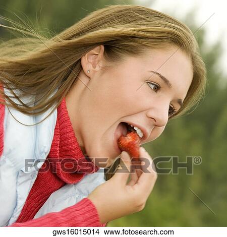Close-up of a teenage girl eating a strawberry View Large Photo Image Picture - Close-up of a teenage girl eating a strawberry. Fotosearch