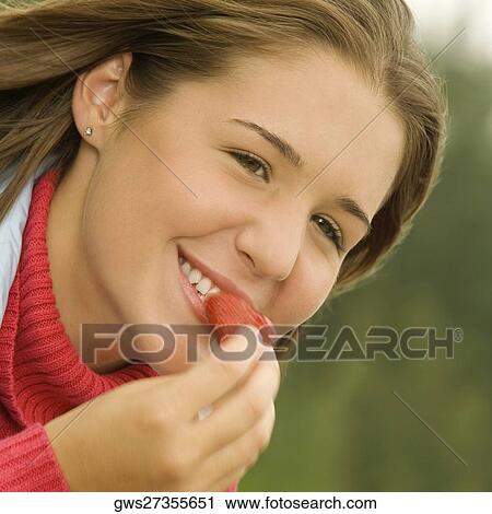 Close-up of a teenage girl eating a strawberry View Large Photo Image Stock Image - Close-up of a teenage girl eating a strawberry. Fotosearch
