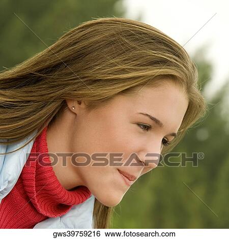 Close-up of a teenage girl looking away View Large Photo Image Stock Photograph - Close-up of a teenage girl looking away. Fotosearch