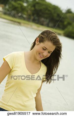 Close-up of a teenage girl walking on the beach smiling View Large Photo Image Stock Photo - Close-up of a teenage girl walking on the beach smiling. Fotosearch