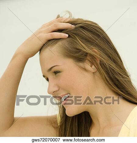 Close-up of a teenage girl with her hand in her hair View Large Photo Image Stock Photo - Close-up of a teenage girl with her hand in her hair. Fotosearch