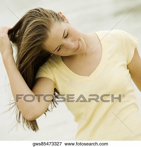 Close-up of a teenage girl with her hand in her hair View Large Photo Image Stock Photo - Close-up of a teenage girl with her hand in her hair. Fotosearch