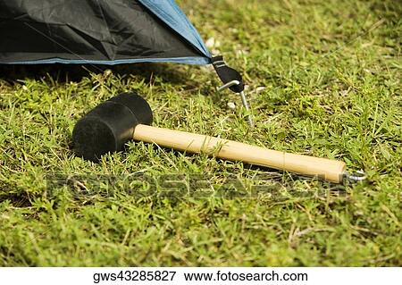 Stock Photo - Close-up of a tent peg and a mallet. Fotosearch