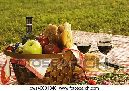 Close-up of a wine bottle with bread and fruits in a picnic basket View Large Photo Image Stock Photo - Close-up of a wine bottle with bread and fruits in a picnic basket. Fotosearch