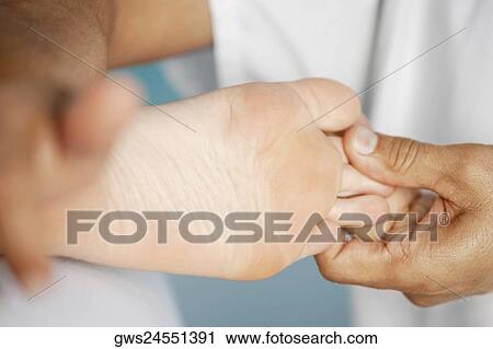 Close-up of a woman getting a foot massage View Large Photo Image Stock Image - Close-up of a woman getting a foot massage. Fotosearch