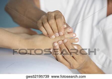 Close-up of a woman getting a foot massage View Large Photo Image Stock Photo - Close-up of a woman getting a foot massage. Fotosearch