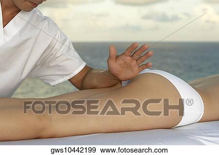 Close-up of a woman getting a massage View Large Photo Image Stock Photo - Close-up of a woman getting a massage. Fotosearch
