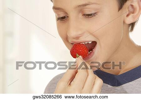 Close-up of a woman's hand feeding a boy a strawberry View Large Photo Image Stock Photograph - Close-up of a woman's hand feeding a boy a strawberry. Fotosearch