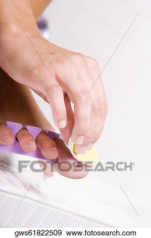 Close-up of a woman's hand shaping her toenail with a nail file View Large Photo Image Stock Photo - Close-up of a woman's hand shaping her toenail with a nail file. Fotosearch