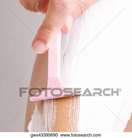 Close-up of a woman's hand shaving her leg View Large Photo Image Stock Image - Close-up of a woman's hand shaving her leg. Fotosearch