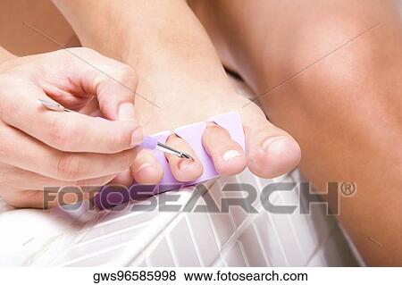 Close-up of a woman's hand using a nail file View Large Photo Image Stock Photo - Close-up of a woman's hand using a nail file. Fotosearch
