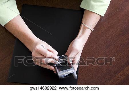 Close-up of a woman's hand using a mobile phone View Large Photo Image Stock Image - Close-up of a woman's hand using a mobile phone. Fotosearch