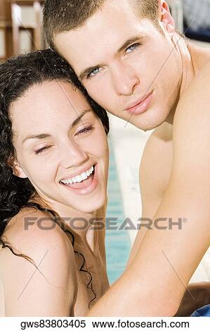 Close-up of a young couple embracing View Large Photo Image Stock Photography - Close-up of a young couple embracing. Fotosearch
