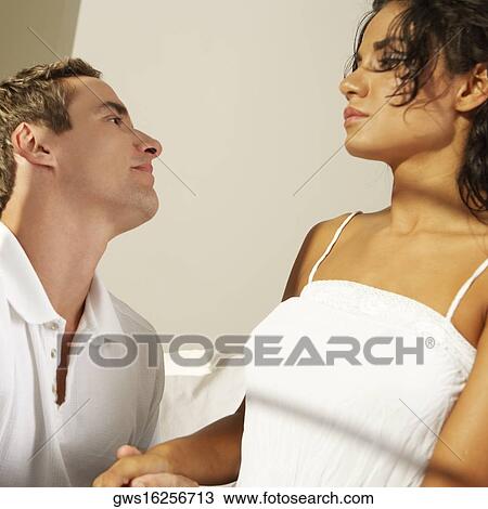 Close-up of a young couple facing each other View Large Photo Image Stock Image - Close-up of a young couple facing each other. Fotosearch