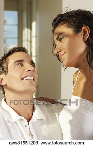 Close-up of a young couple facing each other View Large Photo Image Stock Photo - Close-up of a young couple facing each other. Fotosearch