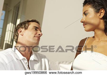 Close-up of a young couple facing each other View Large Photo Image Stock Photograph - Close-up of a young couple facing each other. Fotosearch