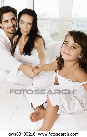 Close-up of a young couple holding their daughter's hands View Large Photo Image Stock Photograph - Close-up of a young couple holding their daughter's hands. Fotosearch
