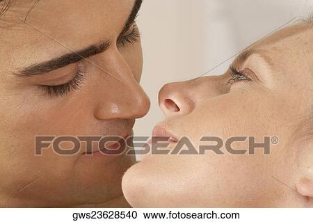 Close-up of a young couple kissing View Large Photo Image Stock Image - Close-up of a young couple kissing. Fotosearch