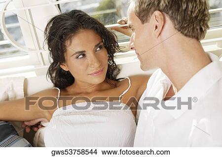 Picture - Close-up of a young couple looking at each other. Fotosearch