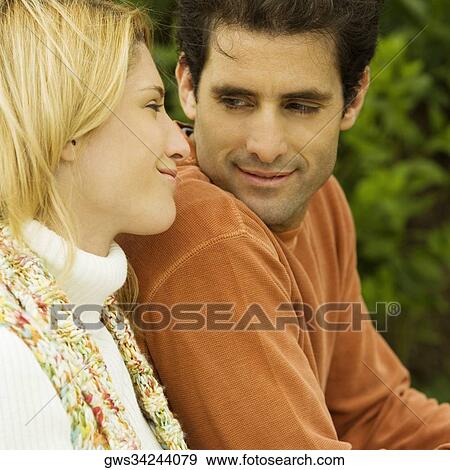 Stock Photo - Close-up of a young couple looking at each other. Fotosearch