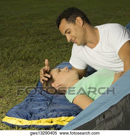 Close-up of a young couple looking at each other View Large Photo Image Stock Photography - Close-up of a young couple looking at each other. Fotosearch