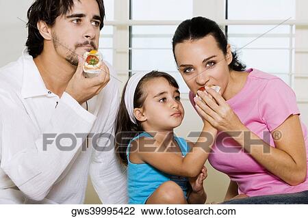 Close-up of a young man eating a pastry View Large Photo Image Stock Image - Close-up of a young man eating a pastry. Fotosearch