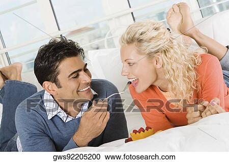 Close-up of a young man feeding salad to a young woman View Large Photo Image Stock Image - Close-up of a young man feeding salad to a young woman. Fotosearch