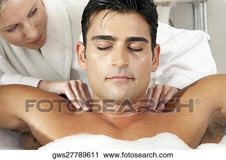 Close-up of a young man getting a massage from a massage therapist View Large Photo Image Stock Image - Close-up of a young man getting a massage from a massage therapist. Fotosearch